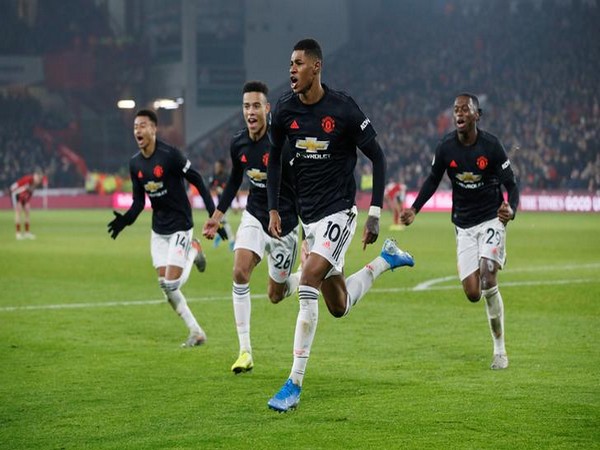 Marcus Rashford celebrating after scoring a goal.