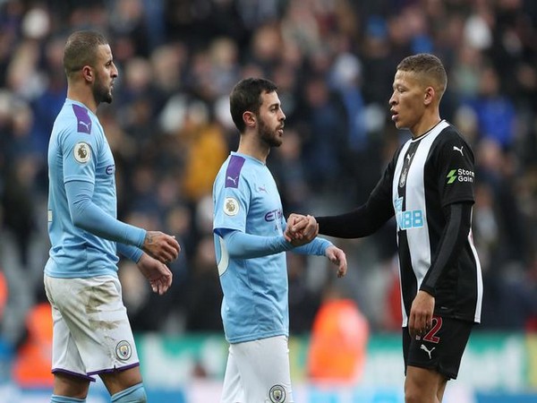 Newcastle United's Dwight Gayle with Manchester City's Bernardo Silva and Kyle Walker