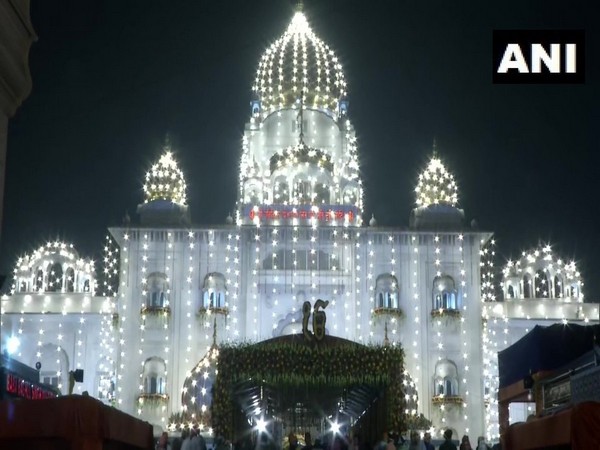 Hundreds of devotees flock to Gurudwara Bangla Sahib in New Delhi early on Tuesday on Guru Purab