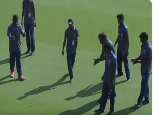 Ground staff getting hold of the snake at the Devineni Venkata Ramana Praneetha ground. (Photo/ BCCI Domestic Twitter) 