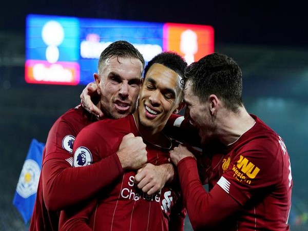 Liverpool's Trent Alexander-Arnold celebrates scoring their fourth goal against Leicester with Jordan Henderson and Andrew Robertson