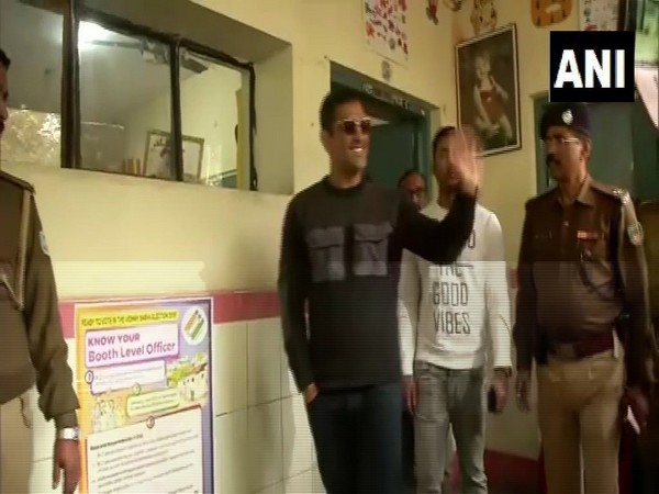 MS Dhoni waving to people after casting his vote outside the polling station in Ranchi. 