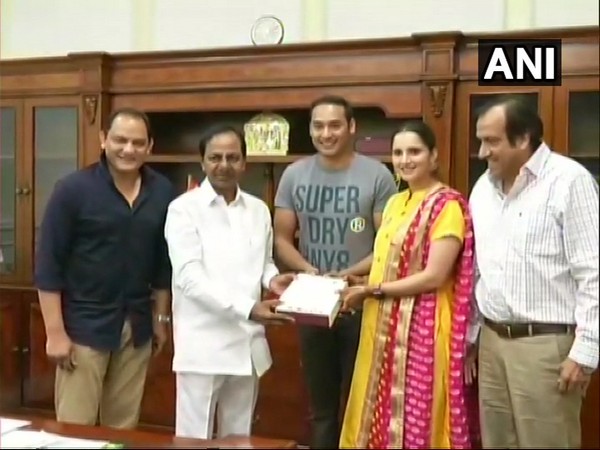 Telangana Chief Minister K Chandrashekar Roa being invited to the wedding reception by Mohammad Azharuddin and Sania Mirza in Hyderabad on Tuesday.