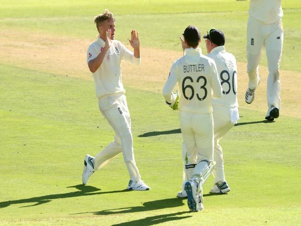 England's Sam Curran celebrates after taking the wicket of South Africa's Rassie van der Dussen with Ollie Pope and Jos Buttler.
