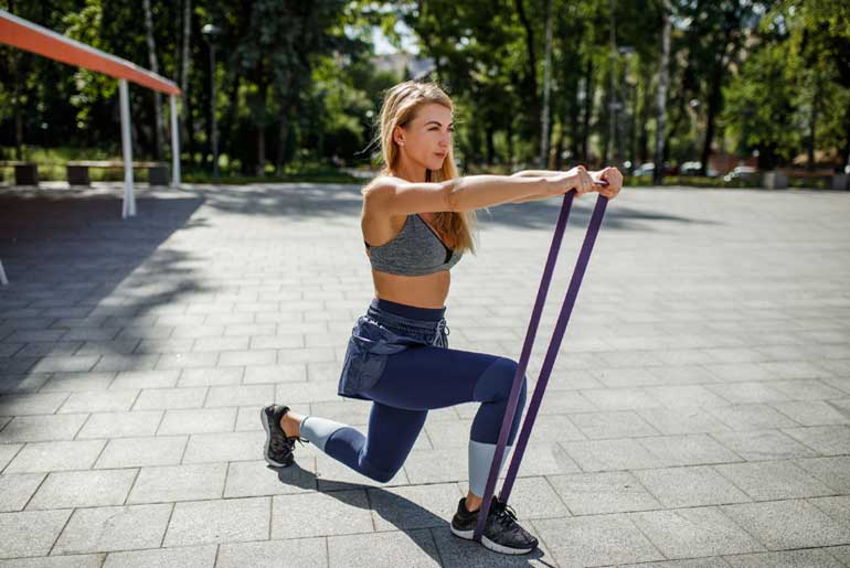 Strong Woman Stretching Using A Resistance Band Stock Photo